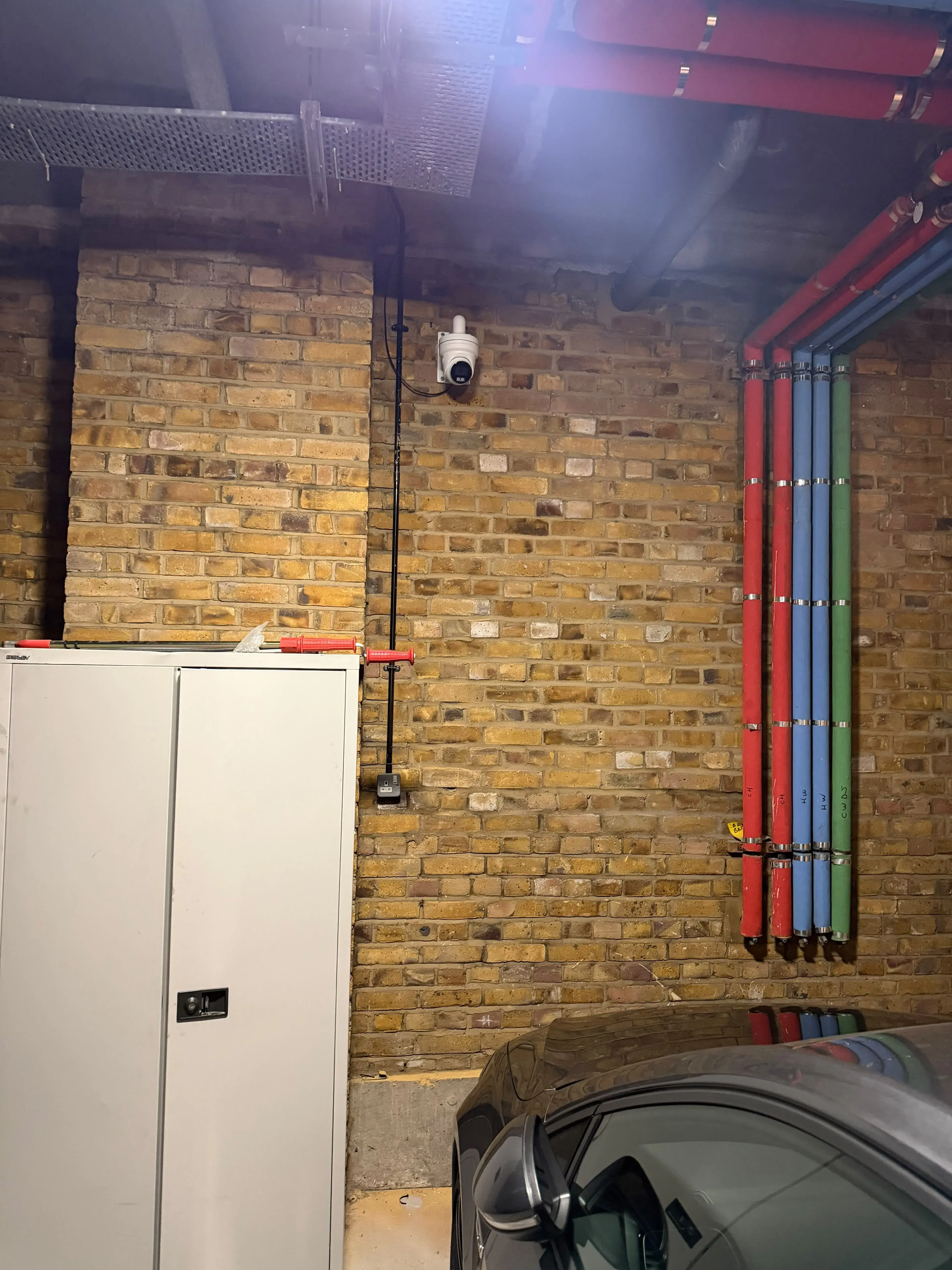 Turret camera installed on a basement car park wall