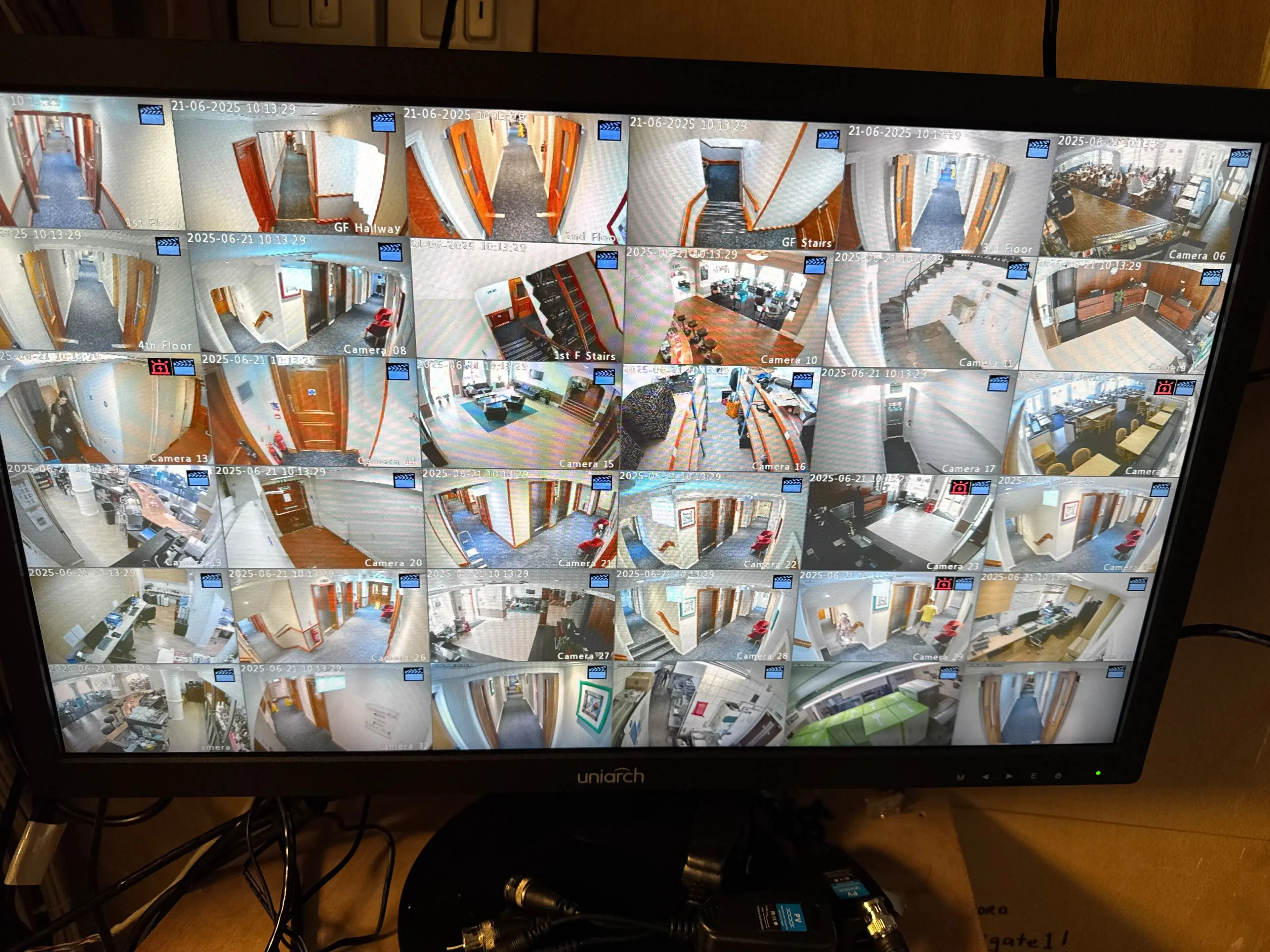 CCTV monitor showing a multi-camera grid view of a building