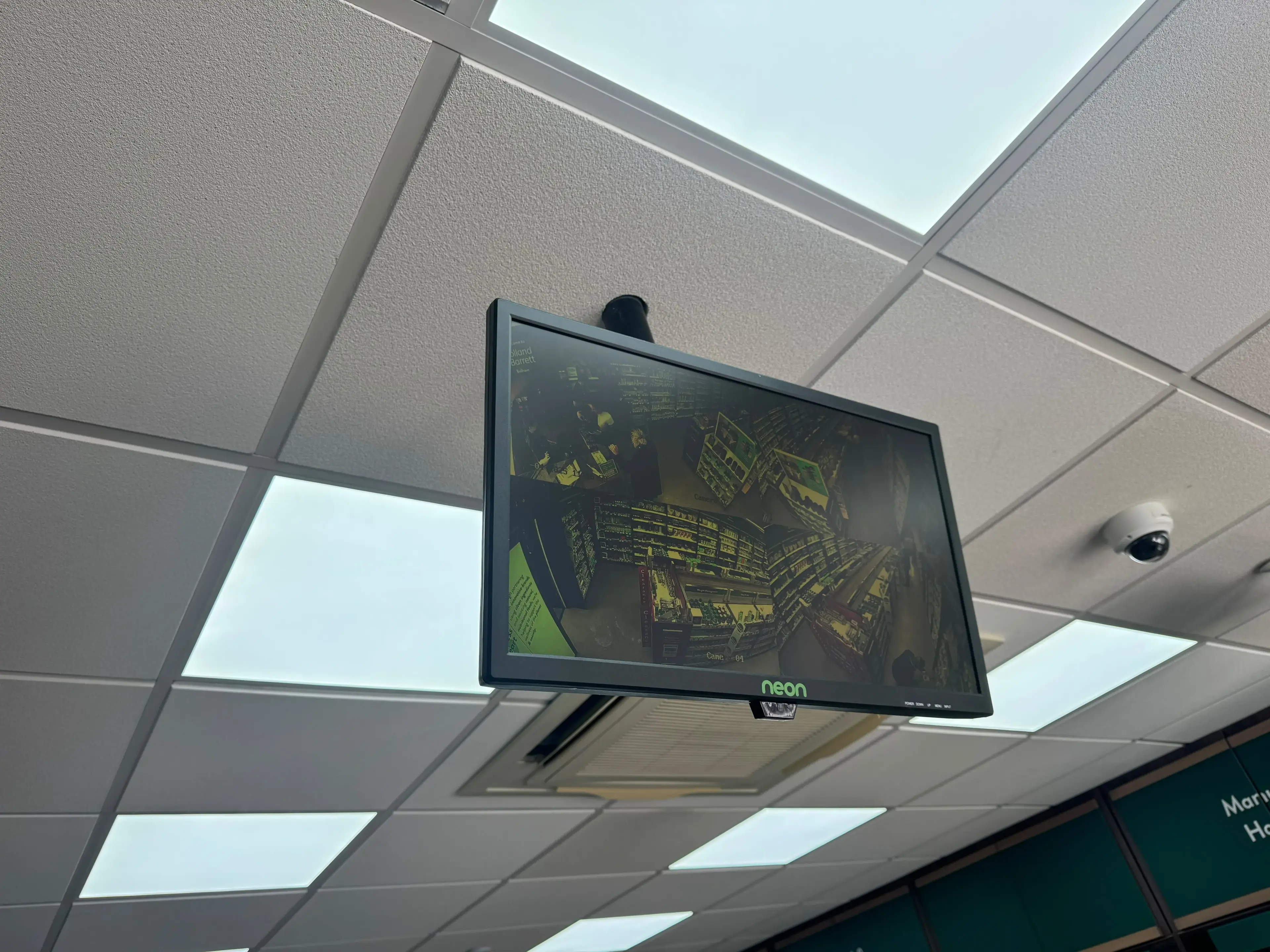 Ceiling-mounted CCTV monitor with a dome camera in a shop