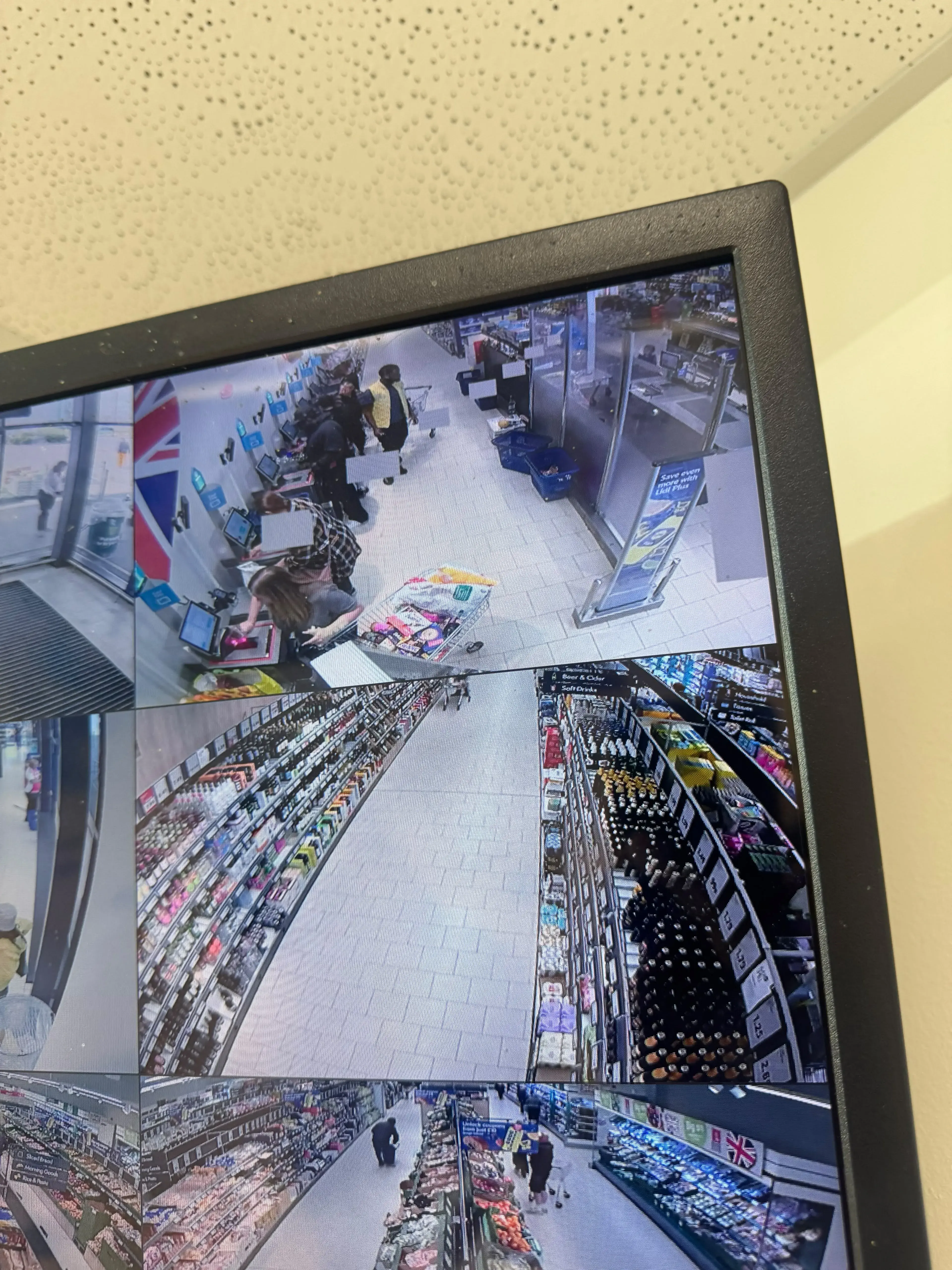 CCTV monitor showing live views of supermarket aisles and tills